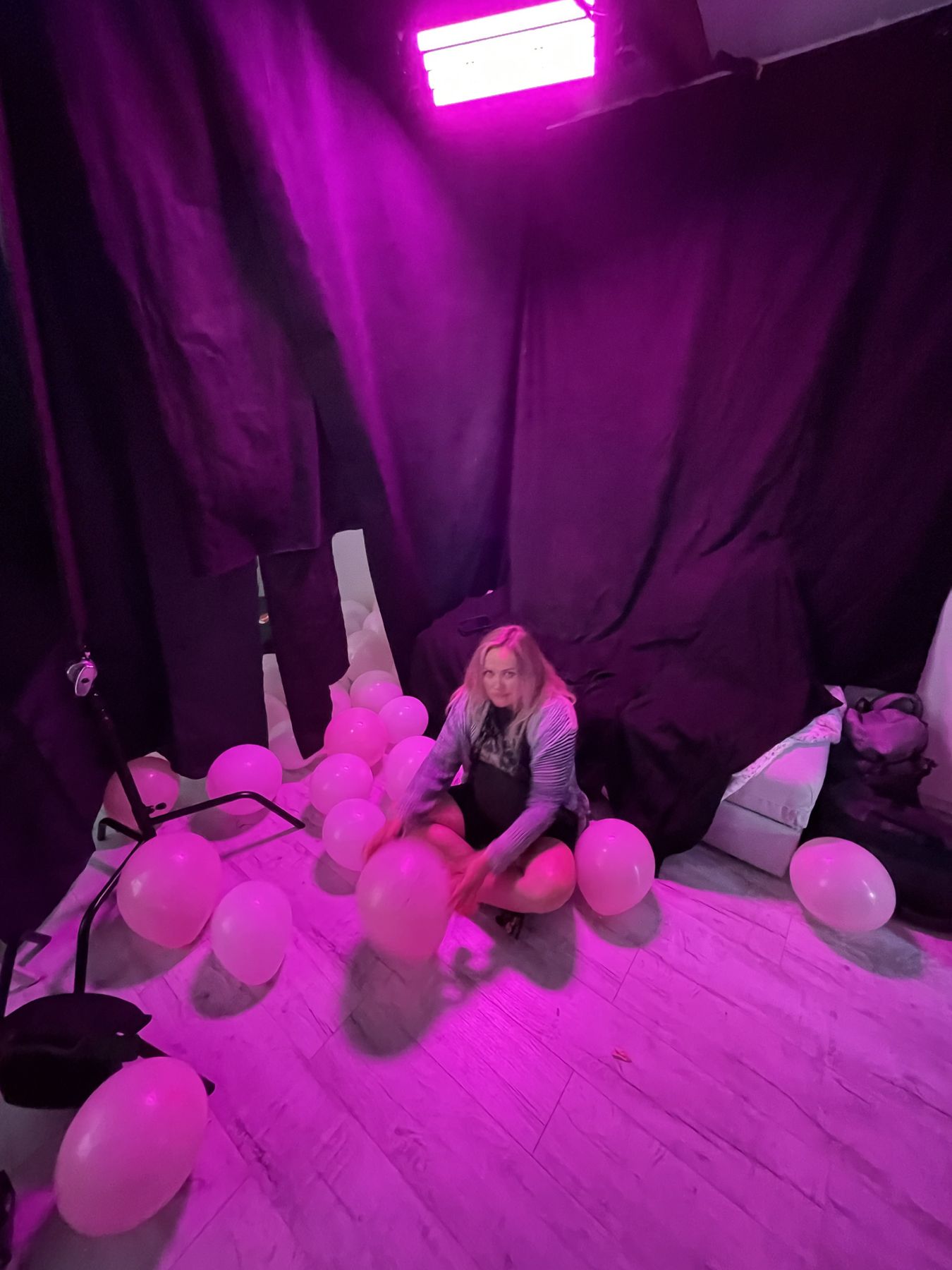 The pink balloon set under magenta light