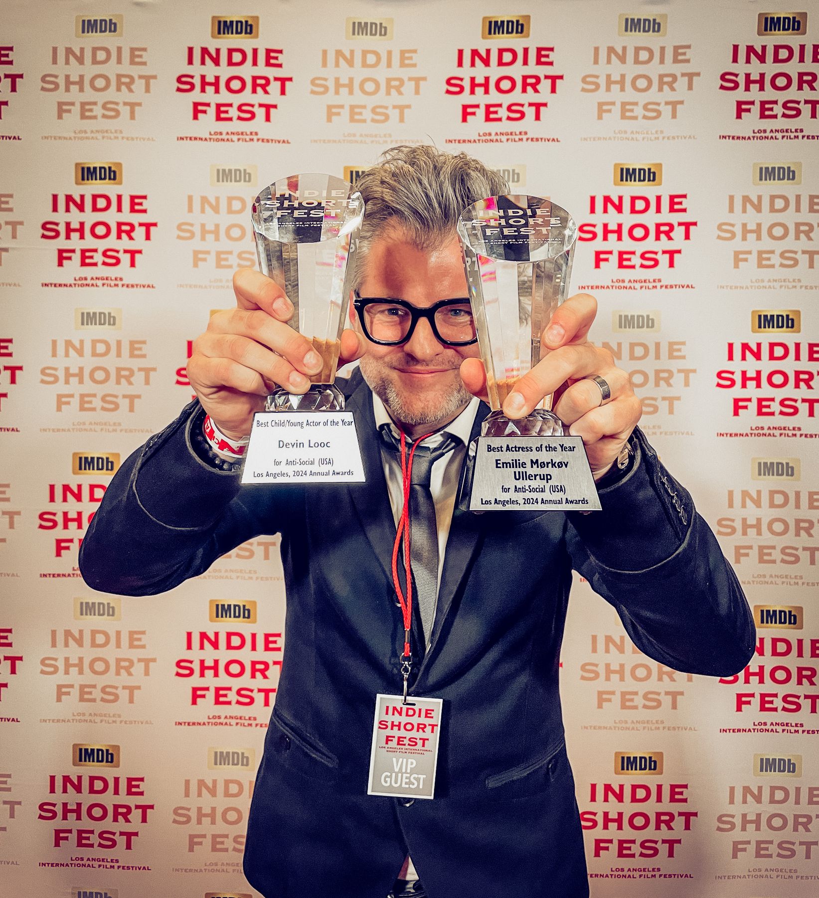 Kyle Cassie holding up two Indie Short Fest trophies