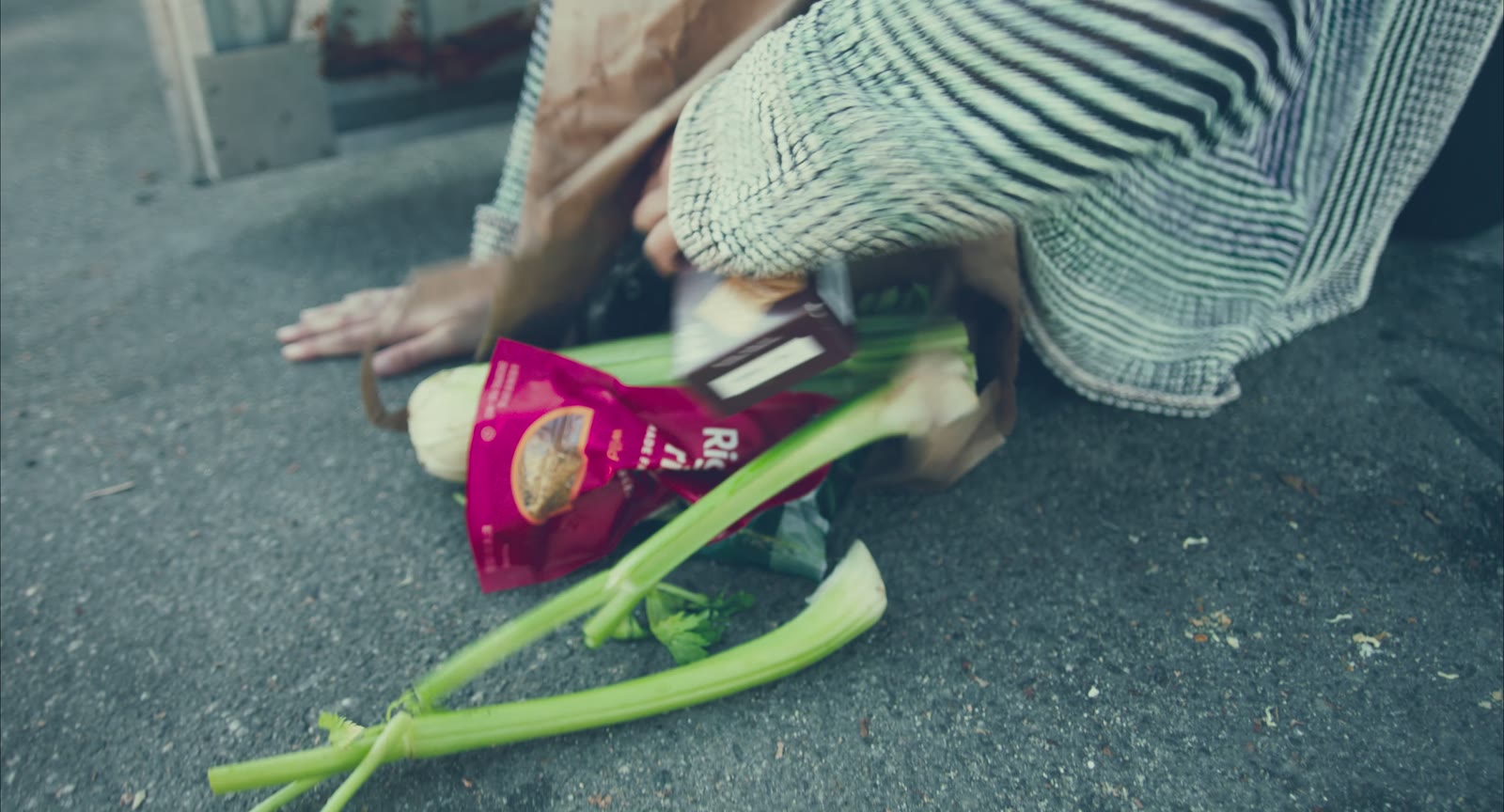 Juniper's groceries spilled on the ground outside the building